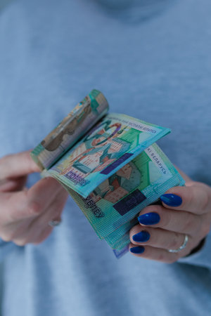Female hands holding paper bills Belarusian rubles