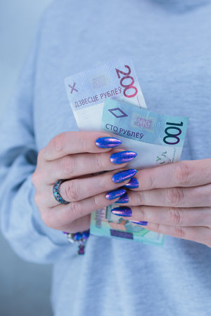 Female hands holding paper bills Belarusian rublesの写真素材