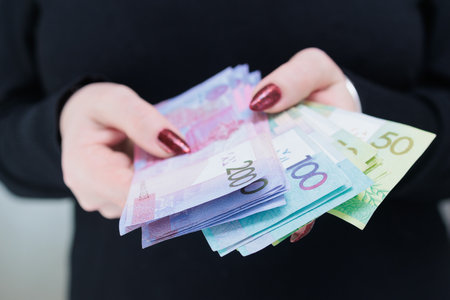 Female hands holding paper bills Belarusian rubles