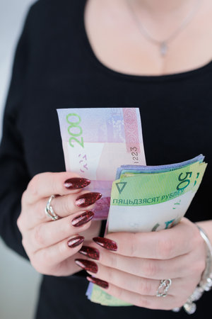 Female hands holding paper bills Belarusian rublesの写真素材