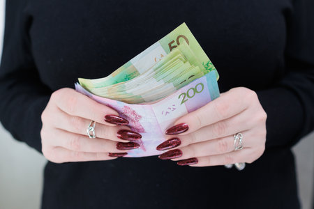 Female hands holding paper bills Belarusian rubles