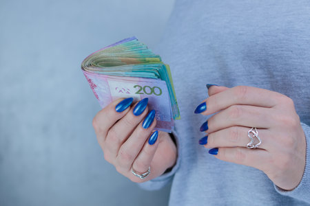 Female hands holding paper bills Belarusian rublesの写真素材