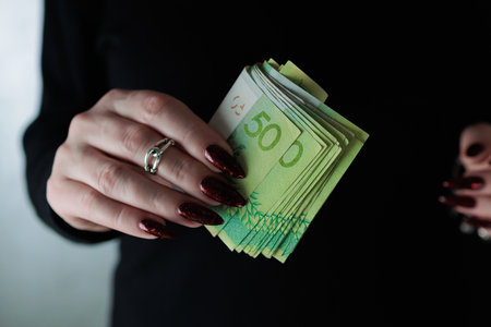 Female hands holding paper bills Belarusian rubles
