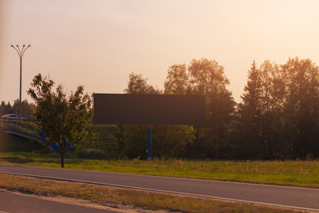 Background for design. Advertising billboard along the road in the city on an autumn sunny eveningの写真素材