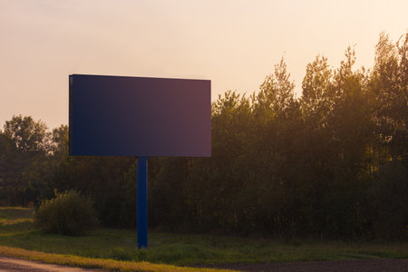 Background for design. Advertising billboard along the road in the city on an autumn sunny eveningの写真素材