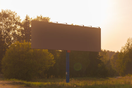 Background for design. Advertising billboard along the road in the city on an autumn sunny eveningの写真素材