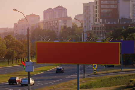 Background for design. Advertising billboard along the road in the city on an autumn sunny eveningの写真素材