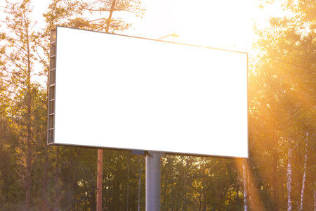 Background for design. Advertising billboard along the road in the city on an autumn sunny eveningの写真素材