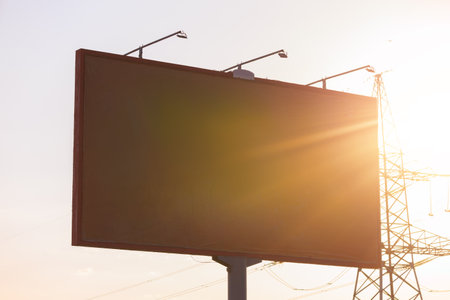Background for design. Advertising billboard along the road in the city on an autumn sunny eveningの写真素材