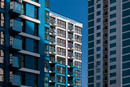 City view on a sunny day. Modern buildings, walls and windows.の写真素材