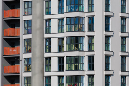 City view on a sunny day. Modern buildings, walls and windows.の写真素材