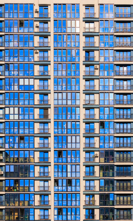 City view on a sunny day. Modern buildings, walls and windows.の写真素材