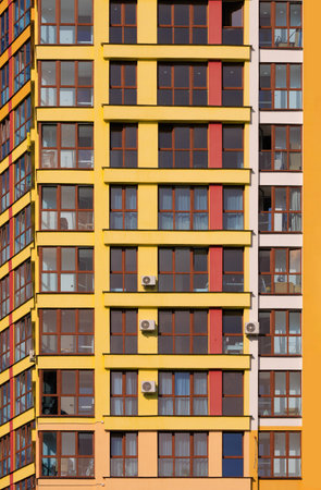 City view on a sunny day. Modern buildings, walls and windows.の写真素材