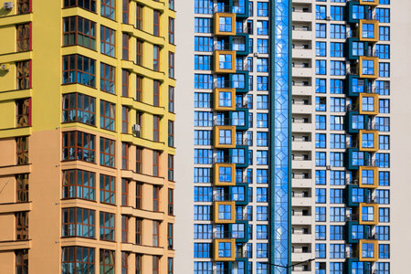 City view on a sunny day. Modern buildings, walls and windows.の写真素材