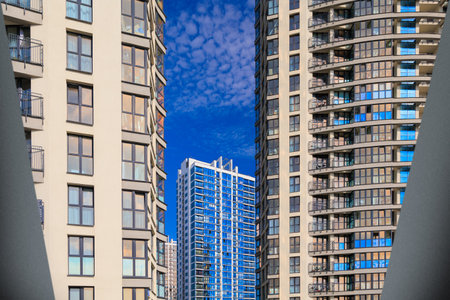 City view on a sunny day. Modern buildings, walls and windows.の写真素材