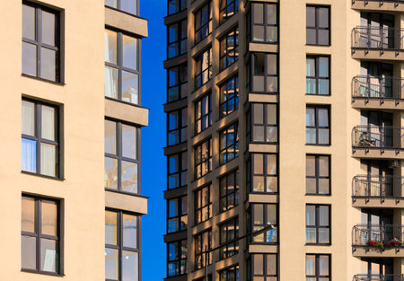 City view on a sunny day. Modern buildings, walls and windows.の写真素材