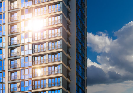 Modern buildings, walls and windows, reflections and sun rays. City view on a sunny day.の写真素材
