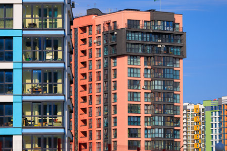 City view on a sunny day. Modern buildings, walls and windows.の写真素材