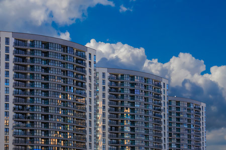 City view on a sunny day. Modern buildings, walls and windows.の写真素材
