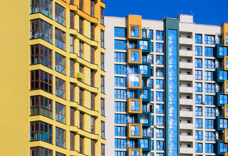 City view on a sunny day. Modern buildings, walls and windows.の写真素材