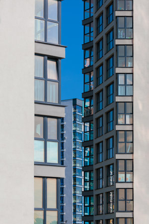 City view on a sunny day. Modern buildings, walls and windows.の写真素材