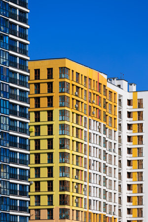 City view on a sunny day. Modern buildings, walls and windows.の写真素材