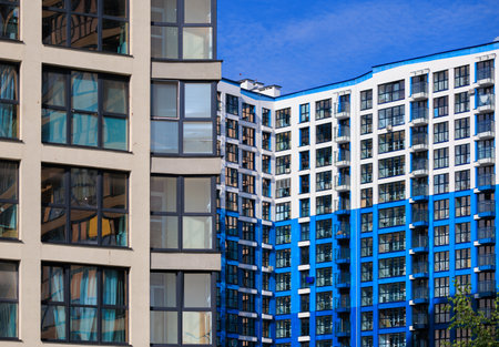 City view on a sunny day. Modern buildings, walls and windows.の写真素材