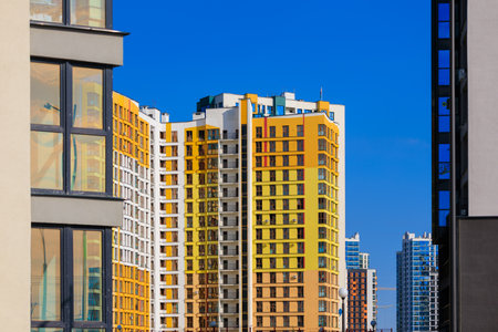 City view on a sunny day. Modern buildings, walls and windows.の写真素材