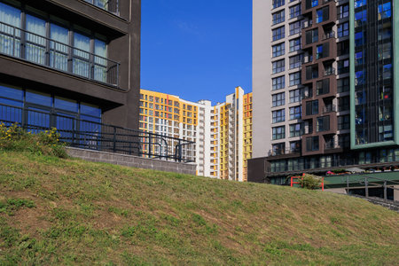 City view on a sunny day. Modern buildings, walls and windows.