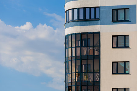 City view on a sunny day. Modern buildings, walls and windows.の写真素材
