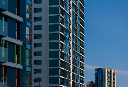 City view on a sunny day. Modern buildings, walls and windows.の写真素材