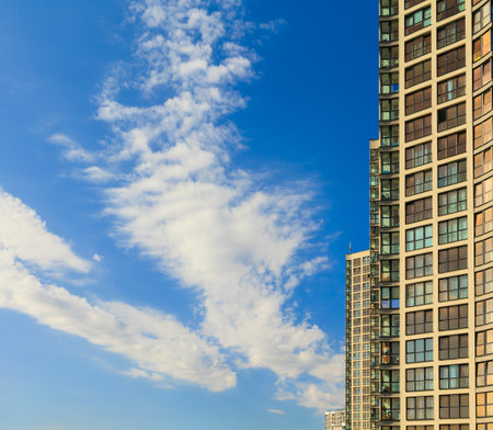 City view on a sunny day. Modern buildings, walls and windows.の写真素材