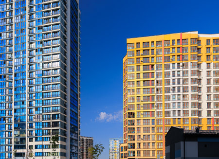 City view on a sunny day. Modern buildings, walls and windows.の写真素材