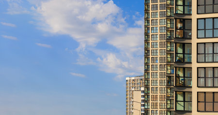 City view on a sunny day. Modern buildings, walls and windows.の写真素材