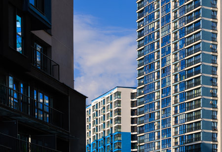 City view on a sunny day. Modern buildings, walls and windows.の写真素材