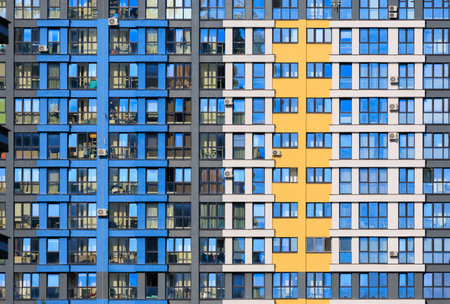 City view on a sunny day. Modern buildings, walls and windows.の写真素材