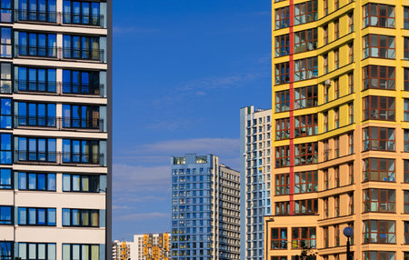 City view on a sunny day. Modern buildings, walls and windows.の写真素材