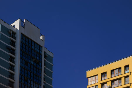 City view on a sunny day. Modern buildings, walls and windows.