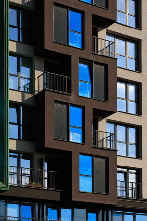 City view on a sunny day. Modern buildings, walls and windows.の写真素材