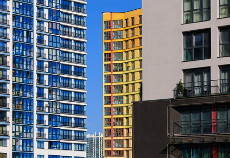 City view on a sunny day. Modern buildings, walls and windows.