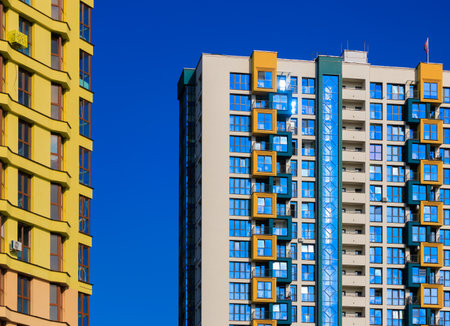 City view on a sunny day. Modern buildings, walls and windows.の写真素材
