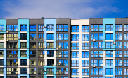 City view on a sunny day. Modern buildings, walls and windows.の写真素材
