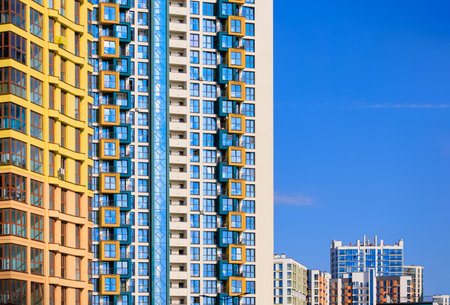 City view on a sunny day. Modern buildings, walls and windows.の写真素材
