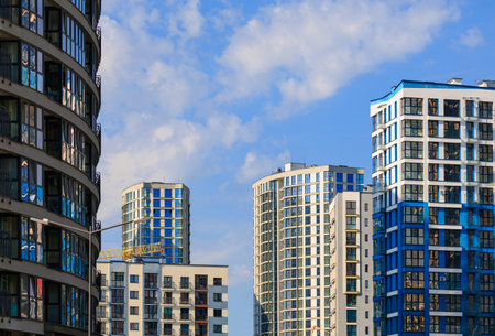 City view on a sunny day. Modern buildings, walls and windows.の写真素材