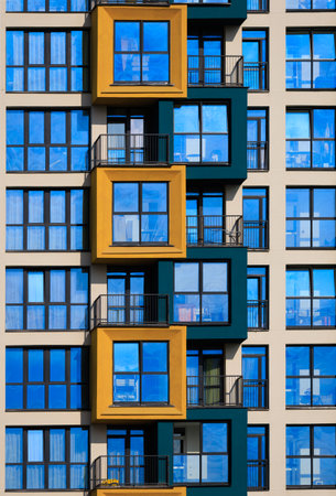 City view on a sunny day. Modern buildings, walls and windows.の写真素材