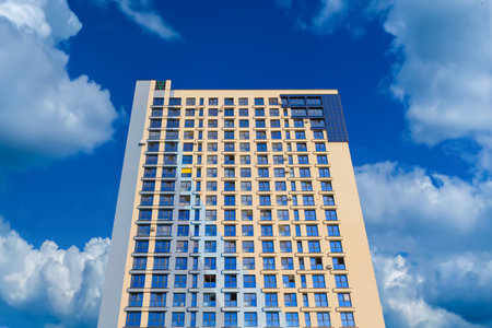 City view on a sunny day. Modern buildings, walls and windows.の写真素材