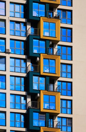 City view on a sunny day. Modern buildings, walls and windows.の写真素材