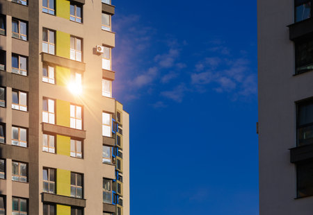 Modern buildings, walls and windows, reflections and sun rays. City view on a sunny day.の写真素材