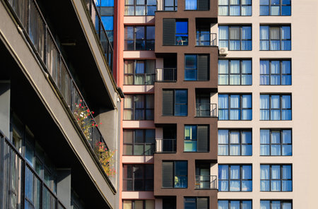 City view on a sunny day. Modern buildings, walls and windows.の写真素材