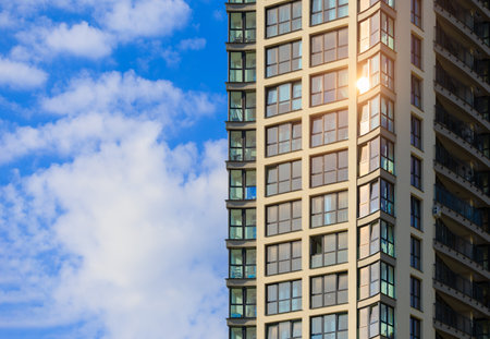 Modern buildings, walls and windows, reflections and sun rays. City view on a sunny day.の写真素材